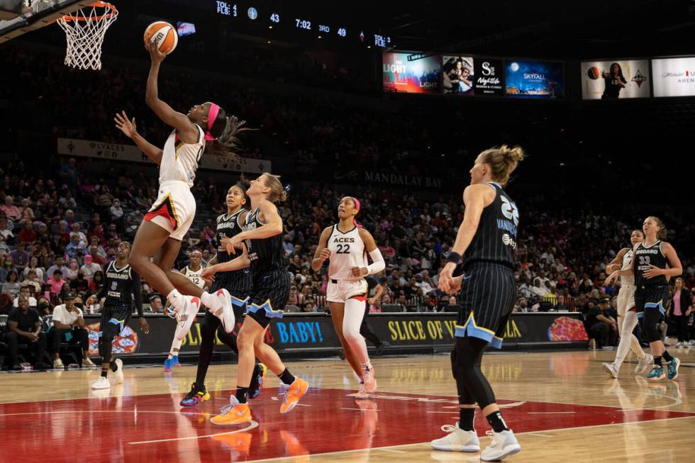 After stealing possession, Las Vegas Aces guard Jackie Young (0) reaches the basket for a layup ...