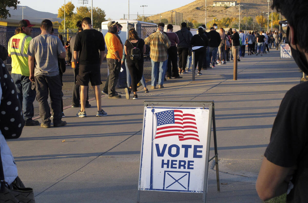 People wait to vote in-person at Reed High School in Sparks, Nev., prior to polls closing on No ...