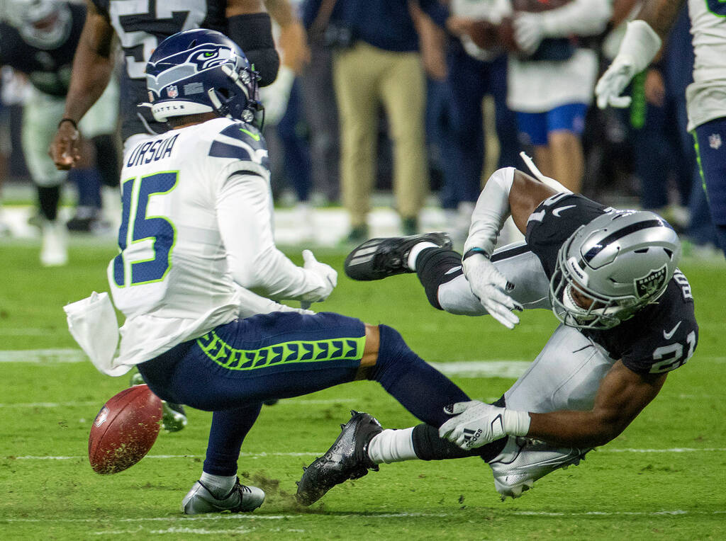 Seattle Seahawks wide receiver John Ursua (15) loses the ball on a kickoff reception after an e ...