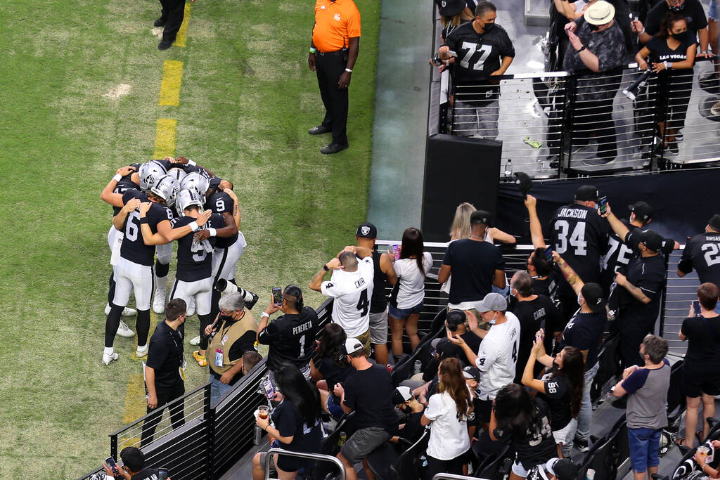 Las Vegas Raiders players huddle before the start of a NFL preseason game against the Seattle S ...