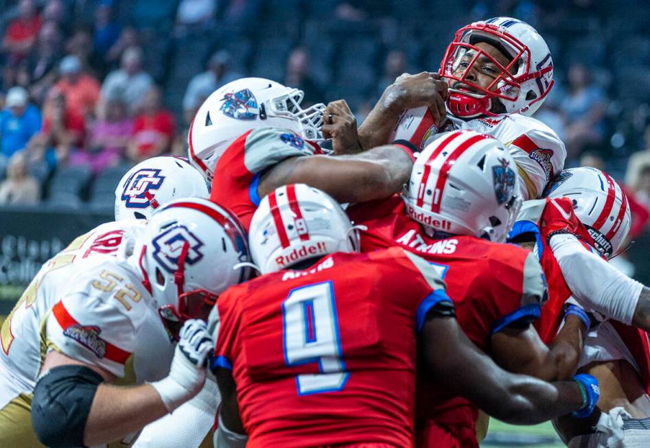 Quad City Steamwheelers quarterback E.J. Hilliard Jr. (12) goes over the top of the Northern Ar ...