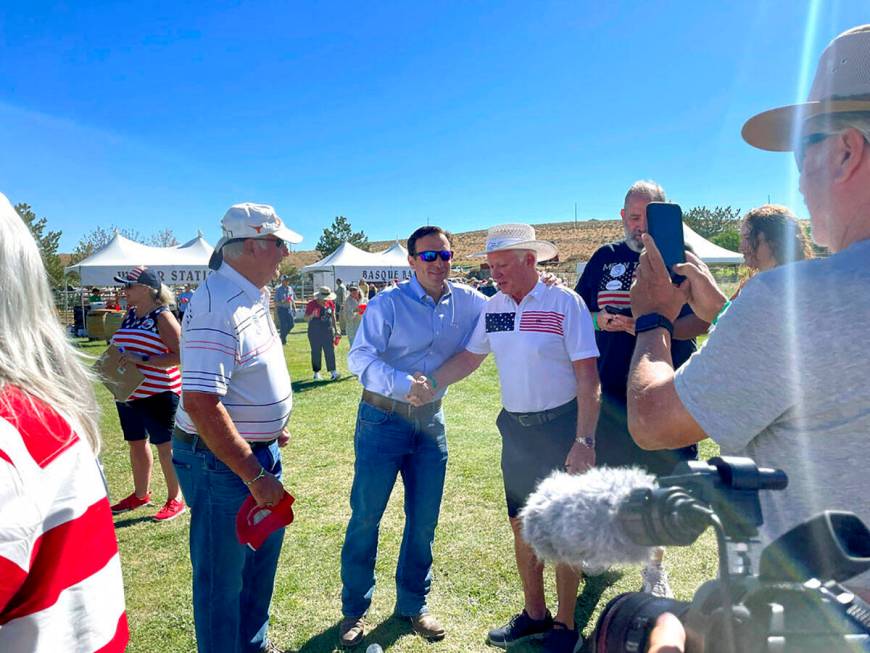 Republican Nevada Senate candidate Adam Laxalt, center left, takes pictures with supporters at ...