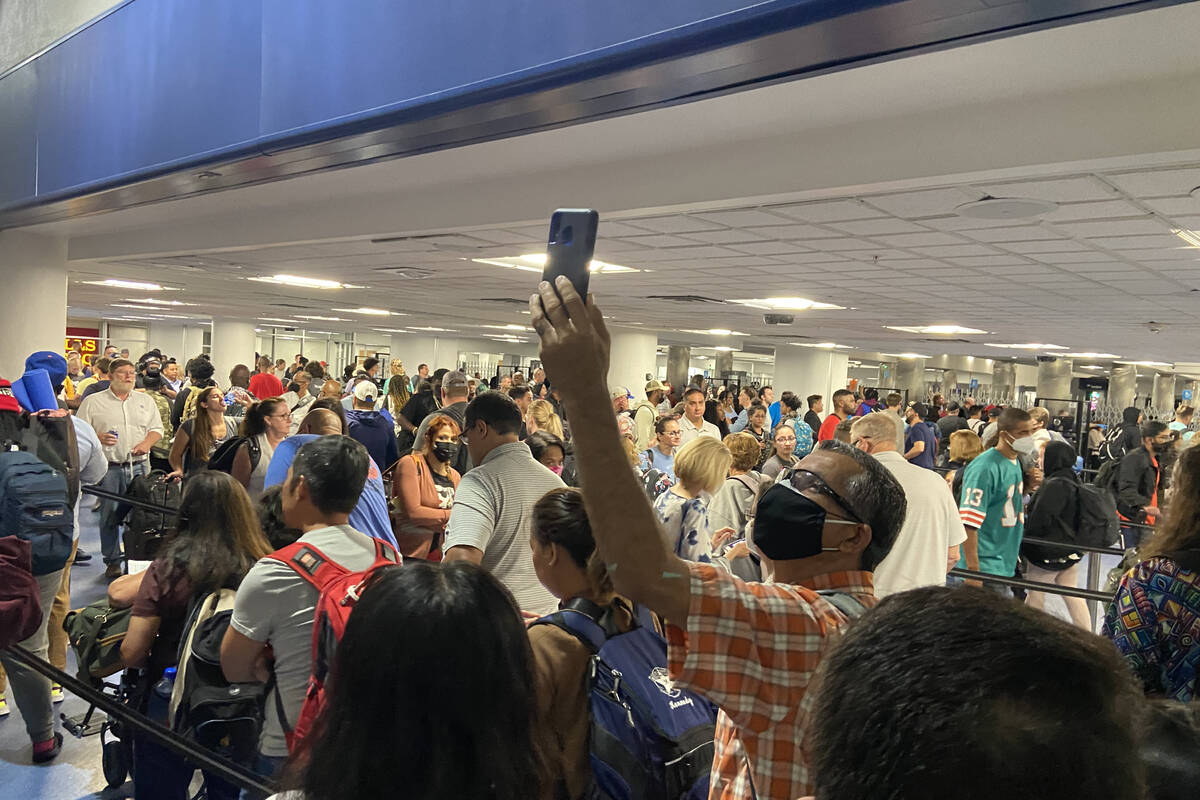 Travelers are held up at Harry Reid International Airport in Las Vegas on August 14, 2022.