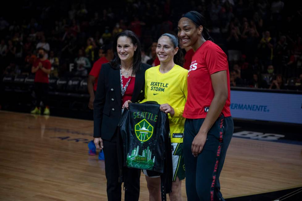 Jennifer Azzi, left, and A'ja Wilson present Sue Bird with a custom leather jacket before the f ...