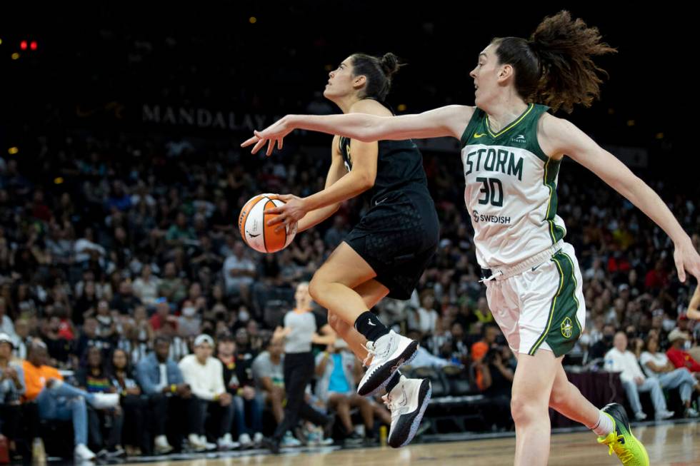 Aces guard Kelsey Plum (10) goes up for a shot past Storm forward Breanna Stewart (30) as the L ...