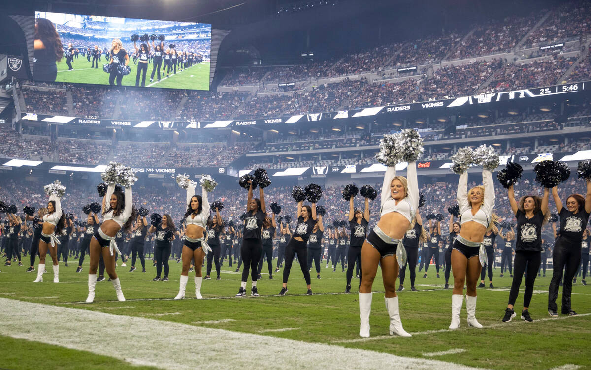 Raiderettes, old and new, perform during halftime for their 60-year anniversary during halftime ...
