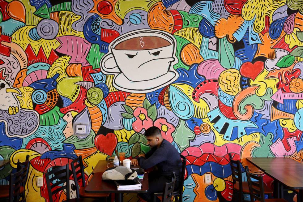 Divyansh Sharma drinks coffee while studying at Grouchy John's Coffee on South Maryland Parkway ...