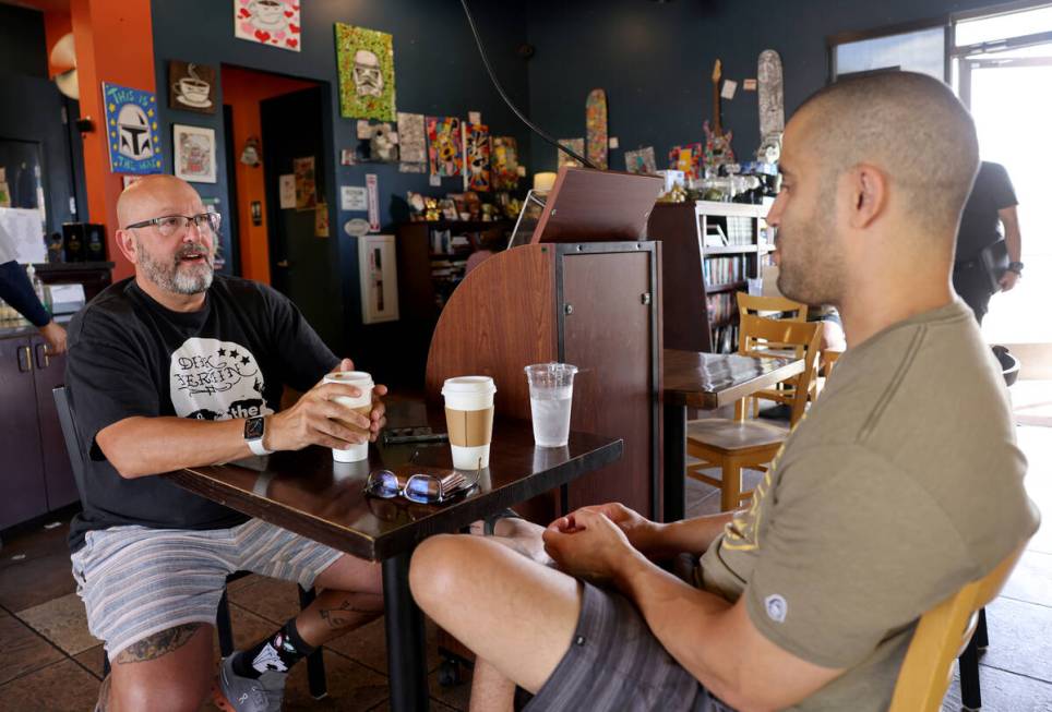 Harry Fagel, left, and Shakeel Abdal-Karim drink coffee while studying at Grouchy John's Coffee ...