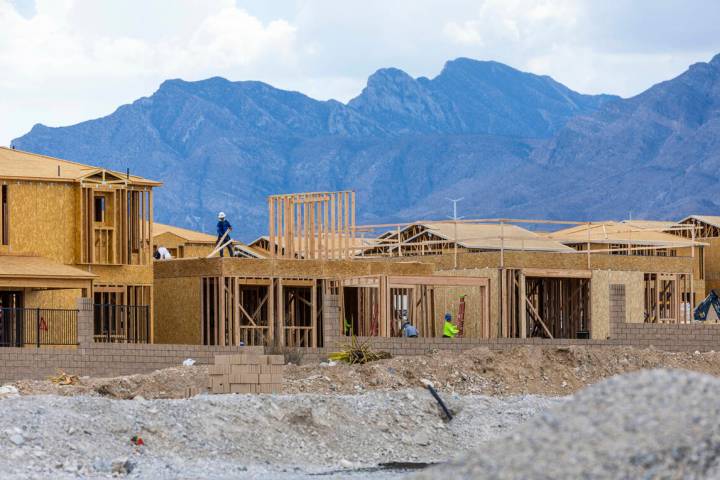 Workers complete framing and walls on new home construction about Skye Canyon on Wednesday, Jul ...