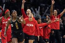 The Las Vegas Aces bench cheers after guard Jackie Young (0) scored a three-pointer against the ...