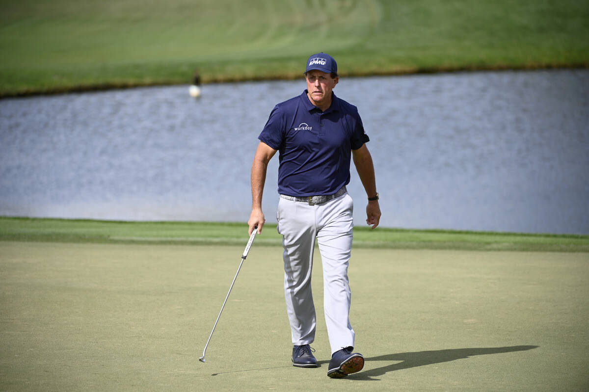Phil Mickelson reacts to a putt on the eighth green during the first round of the Arnold Palmer ...