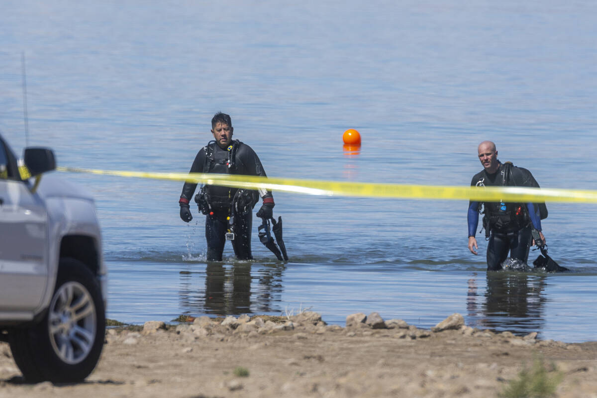 Divers leave the water as authorities are assessing what were described as skeletal remains fou ...