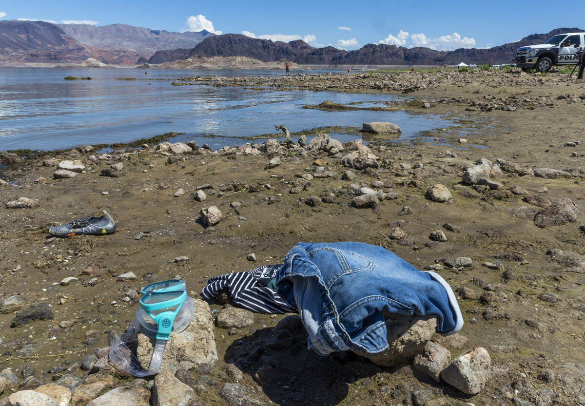 Clothing and a dive mask are some of the things left behind along the shoreline as authorities ...