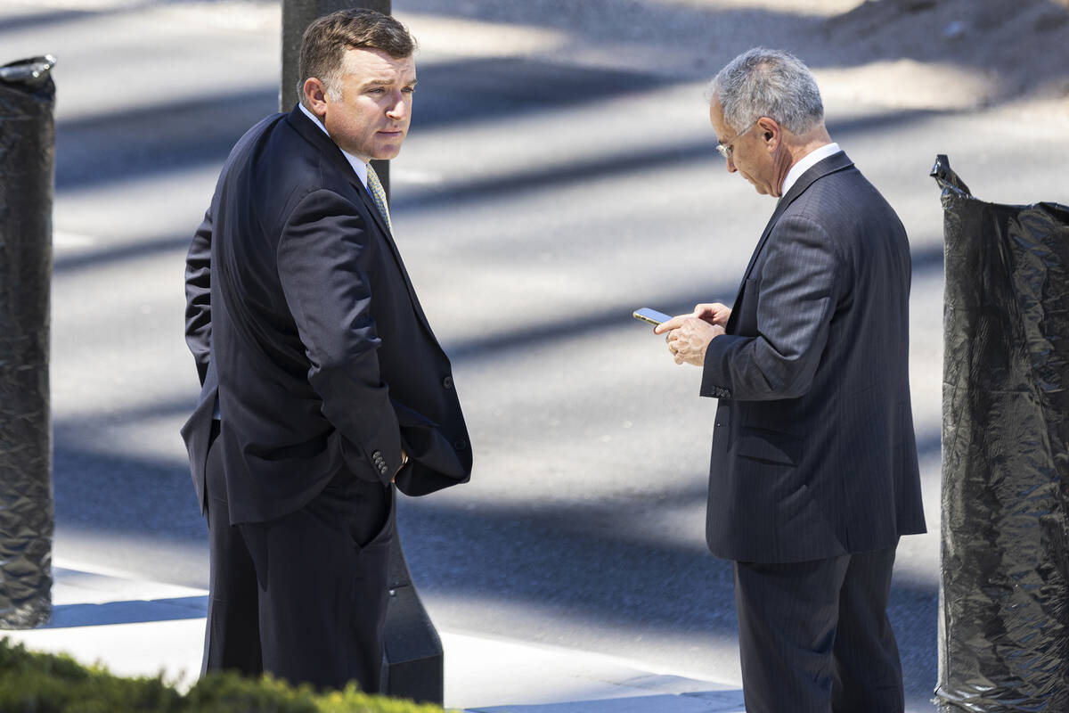 FBI agent Scott Carpenter, 40, left, and his attorney Paul Fishman wait for their ride outside ...
