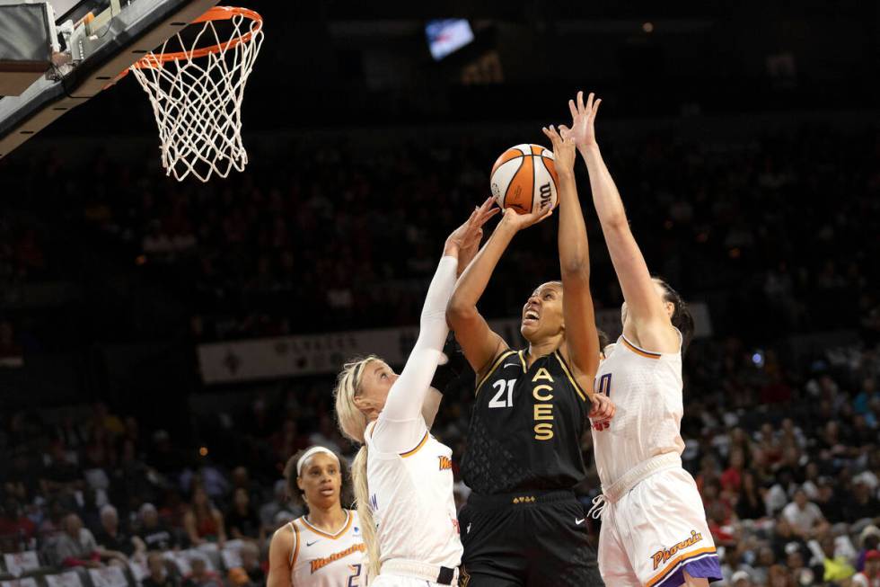 Las Vegas Aces center Iliana Rupert (21) shoots against Phoenix Mercury guard Sophie Cunningham ...