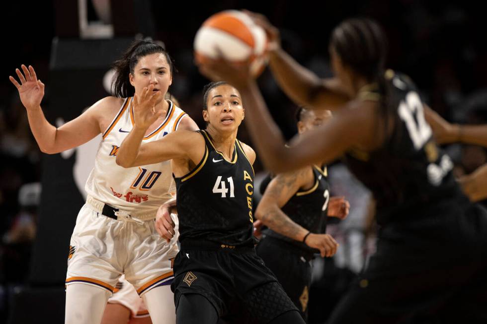 Las Vegas Aces center Kiah Stokes (41) eyes the ball while guard Chelsea Gray (12) attempt to p ...