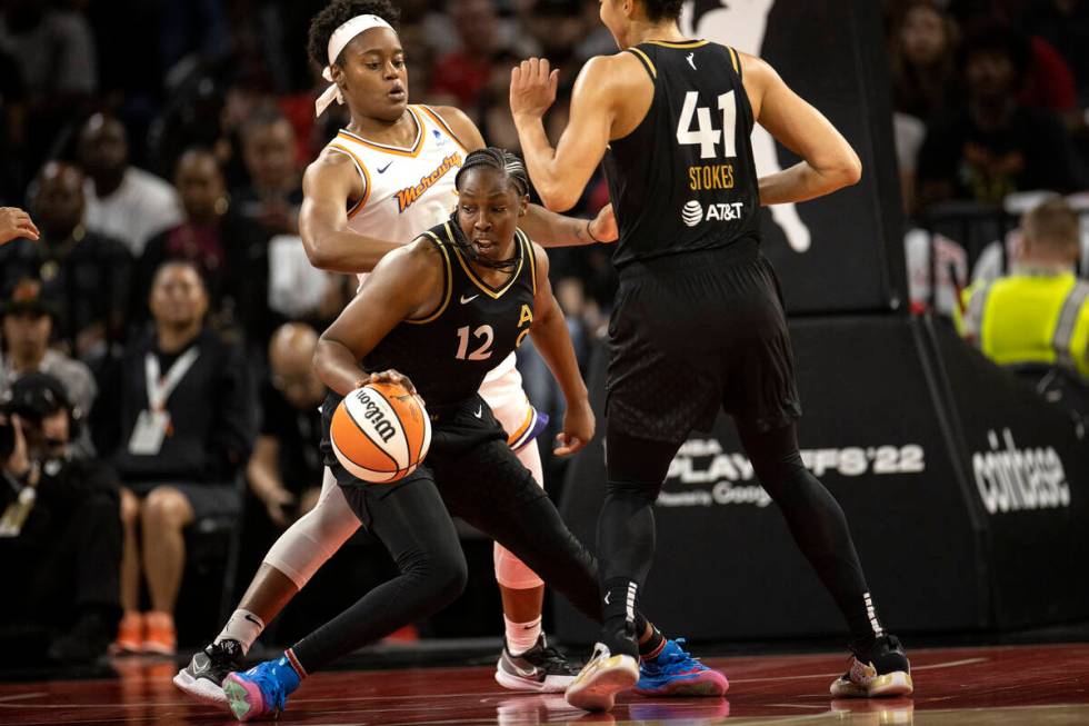 Las Vegas Aces guard Chelsea Gray (12) dribbles around Phoenix Mercury guard Kaela Davis (3) du ...