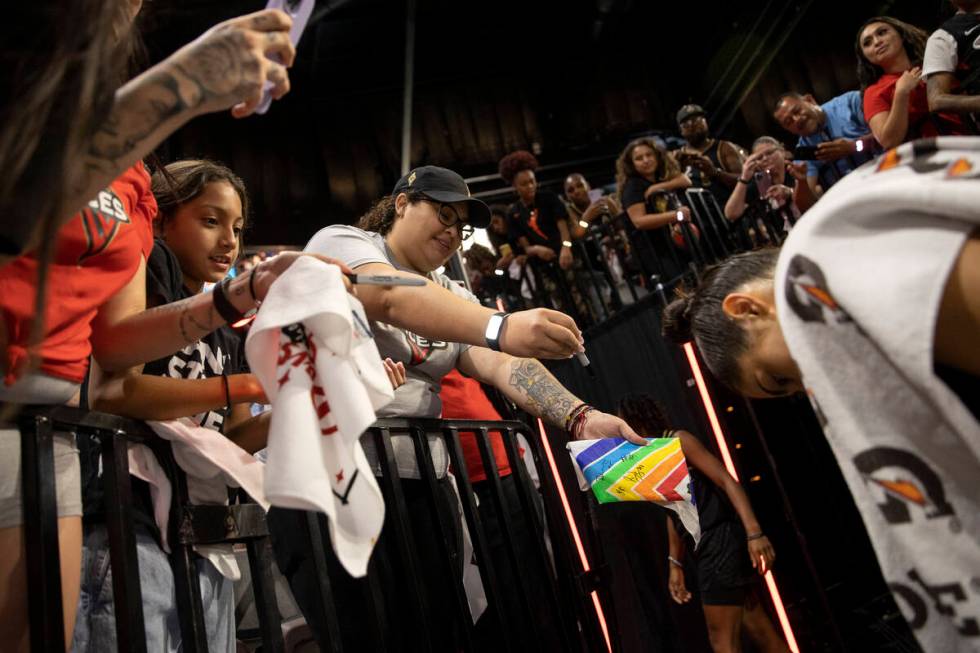 Las Vegas Aces guard Kelsey Plum (10) signs autographs for fans after the Aces won a WNBA playo ...