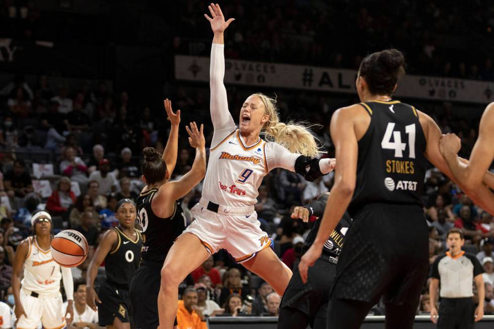 Phoenix Mercury guard Sophie Cunningham (9) falls while shooting against Las Vegas Aces guard K ...