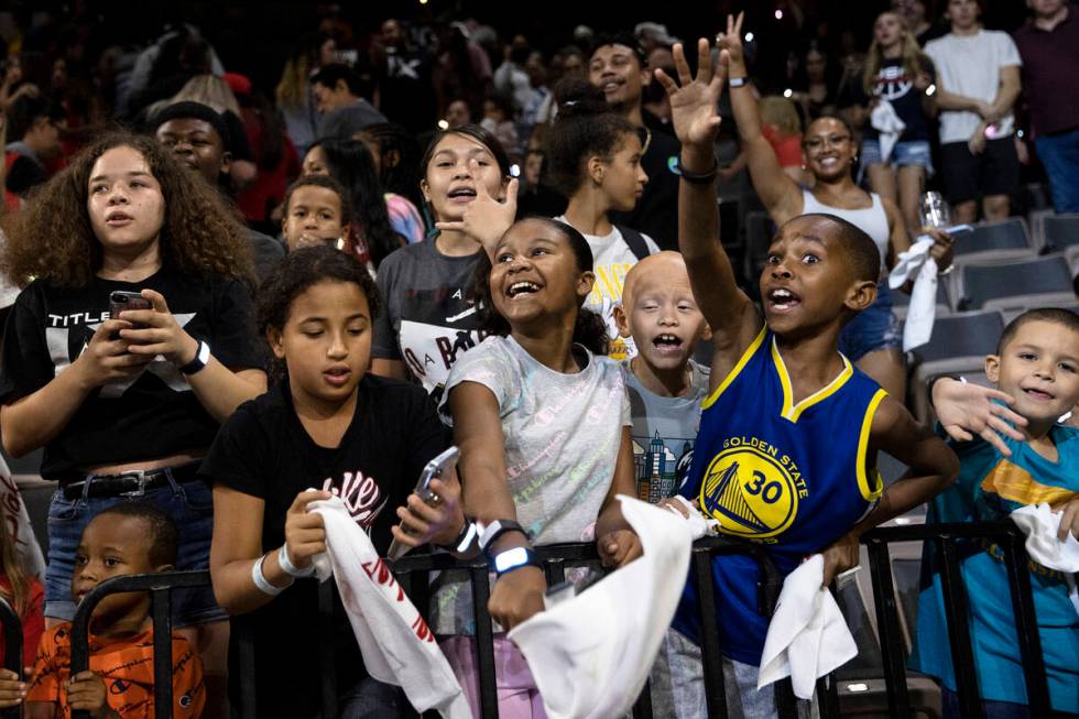 Young Las Vegas Aces fans cheer for their team after they won a WNBA playoff basketball game ag ...