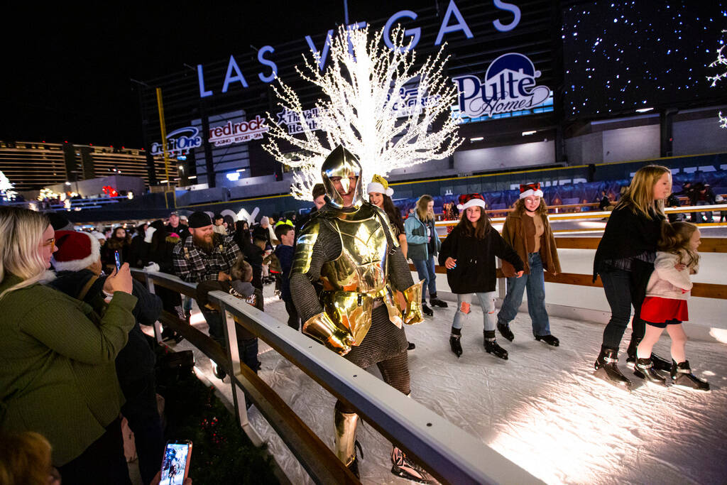 Lee Orchard, the Golden Knight, skates with attendees during the "Knight of Giving" a ...