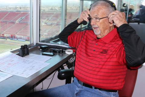 The "Voice of the Rebels", Dick Calvert, puts on his headset prior to calling the act ...