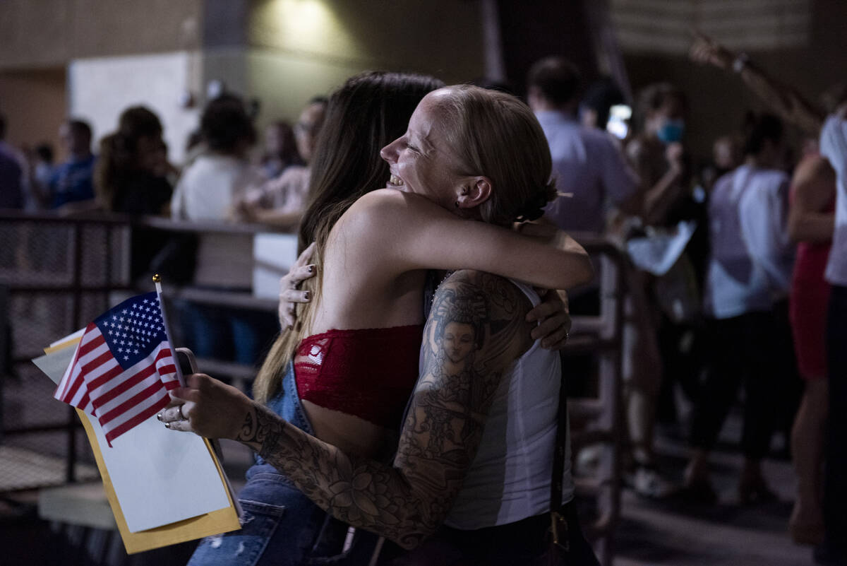 Sarah Belmore Hays, left, hugs Lisa Warner-Pollack after Warner-Pollack became a U.S.citizen du ...