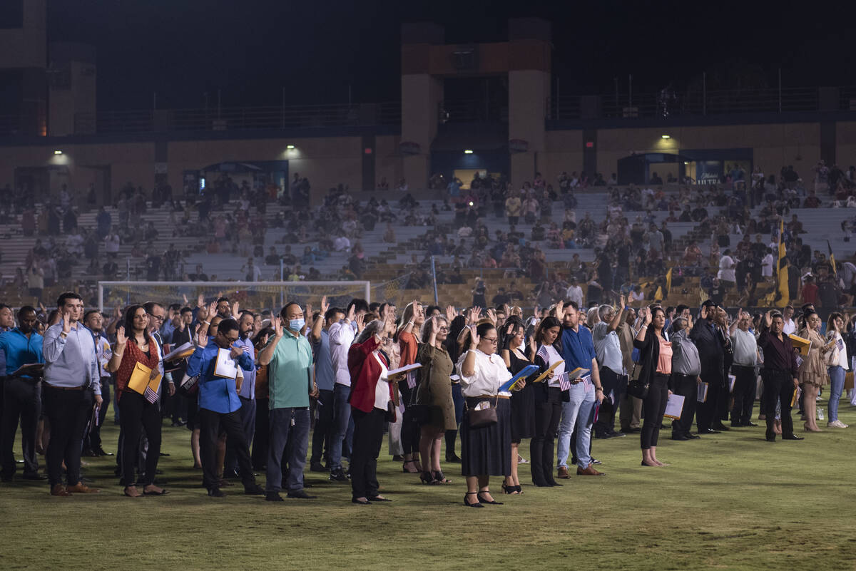 About 700 people become U.S. citizens during a naturalization ceremony at halftime of the Las V ...
