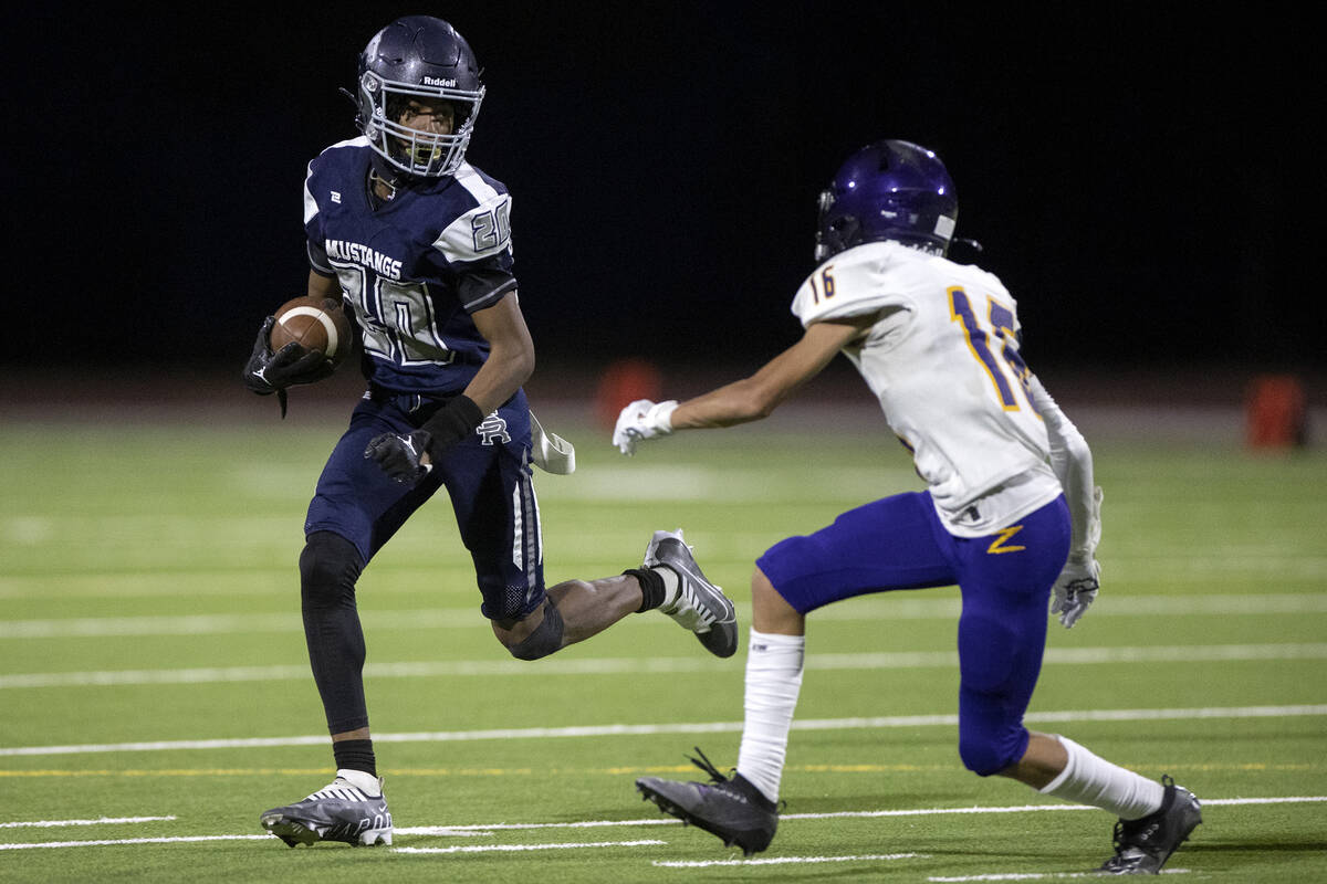Shadow Ridge wide receiver Miah Campbell (20) evades a tackle from Durango free safety Tyler Pa ...