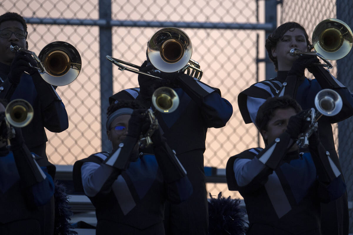 The Shadow Ridge horn section of the marching band plays during a Class 4A high school football ...