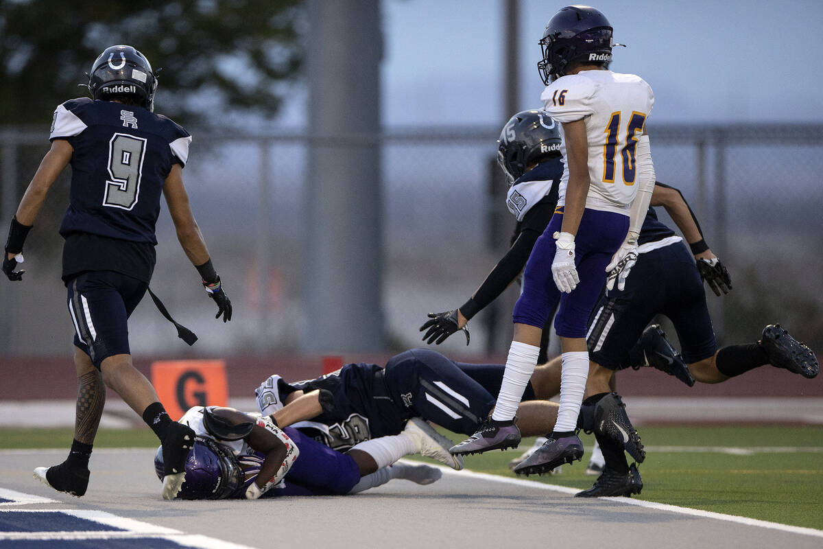 Durango running back Keimarion Taylor (26) is tackled into the end zone while scoring a touchdo ...