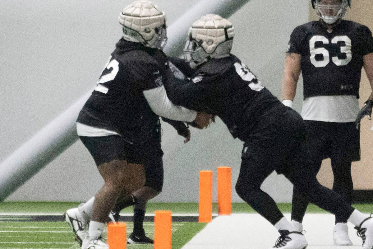 Raiders defensive tackle Kyle Peko (92), left, and defensive tackle Neil Farrell Jr. (93) drill ...