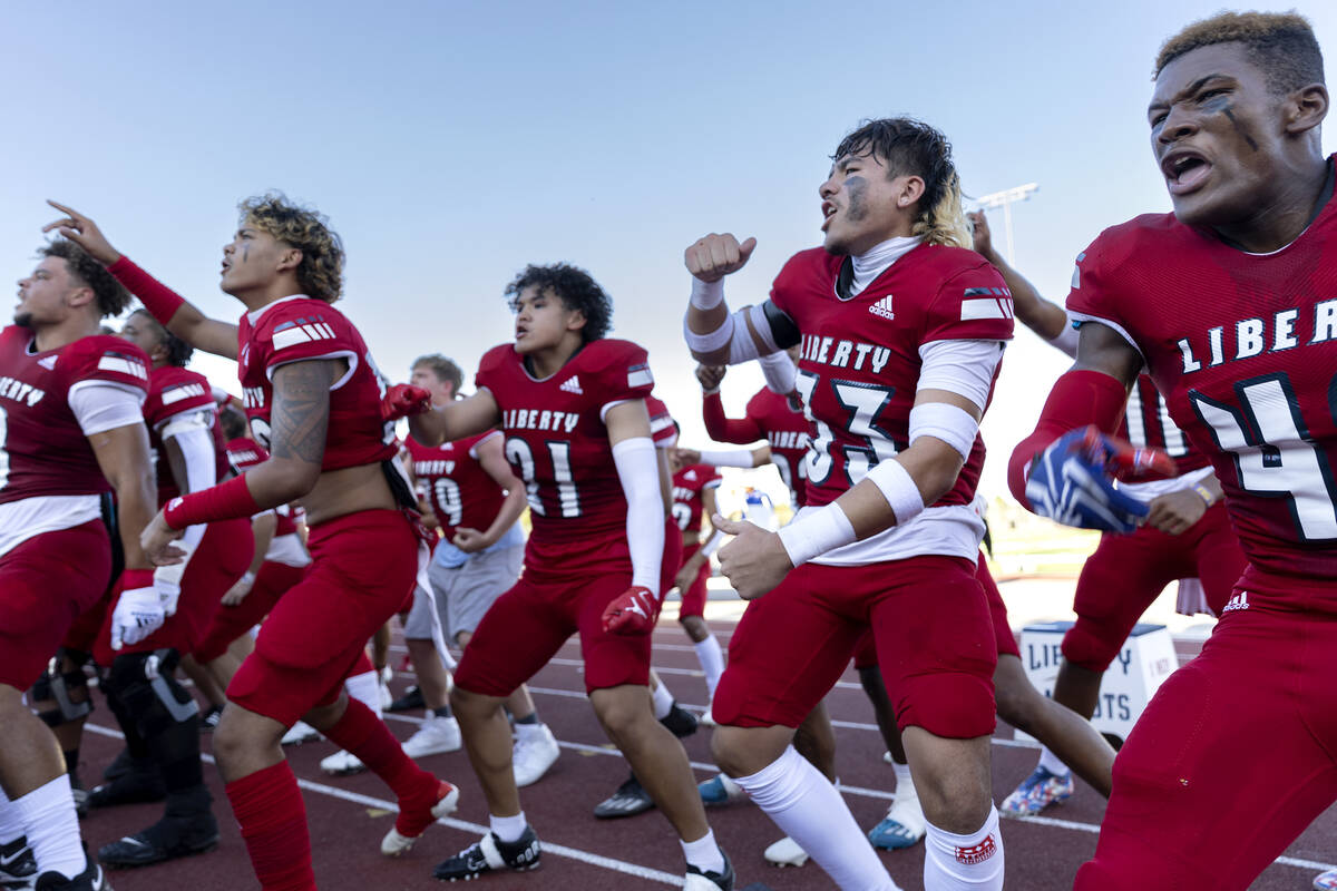 Liberty players pump up the crowd before a Class 4A high school football game against Palo Verd ...