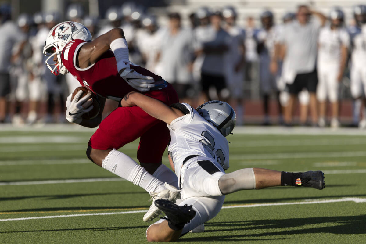 Palo Verde tight end Jake Fields (22) tackles Liberty wide receiver Landon Bell (5) during a C ...