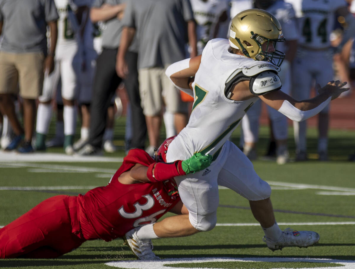 Arbor View High School's Marcus Young (36) tackles Snow Canyon's Hunter Johnson (17) during the ...