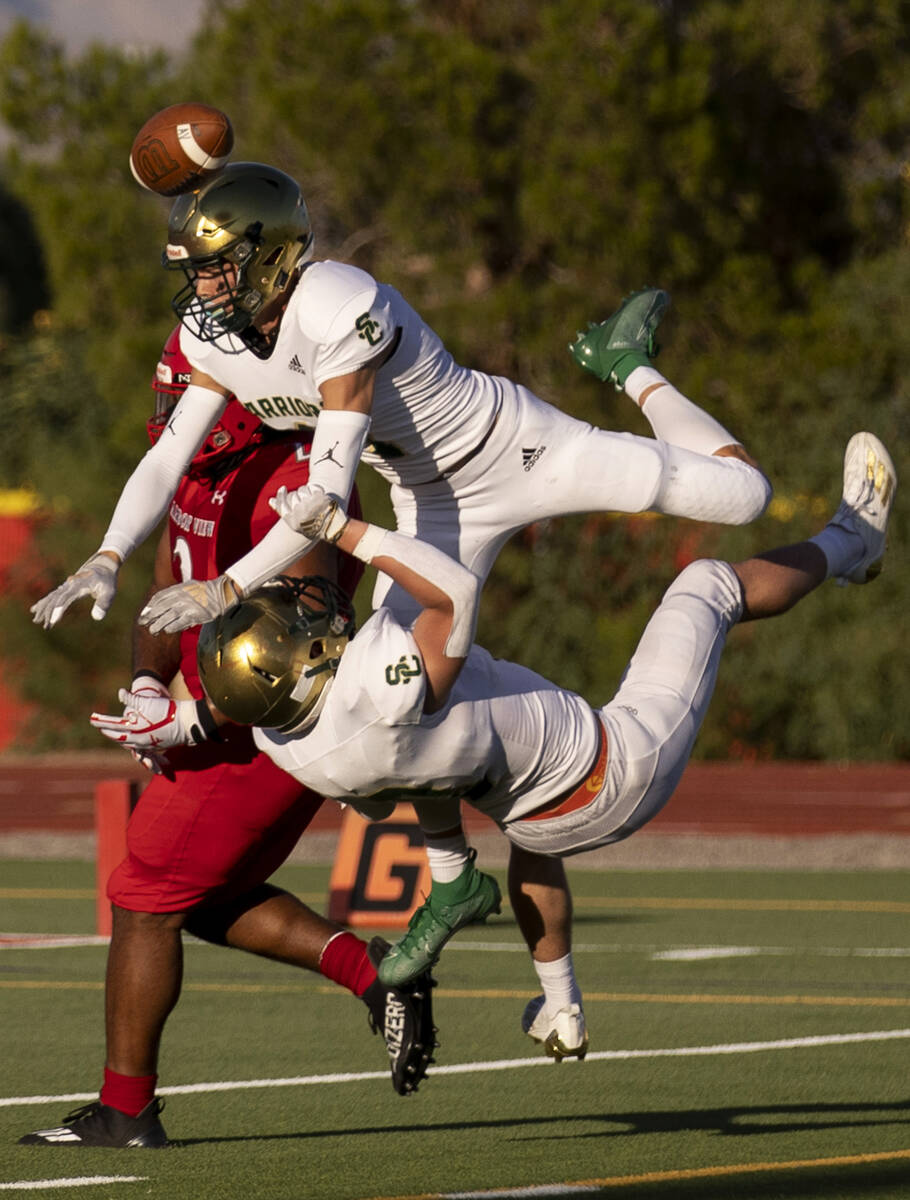 Snow Canyon's Will Warner (1) and Dahrius Romander (0) block a pass to Arbor View's Juice Washi ...