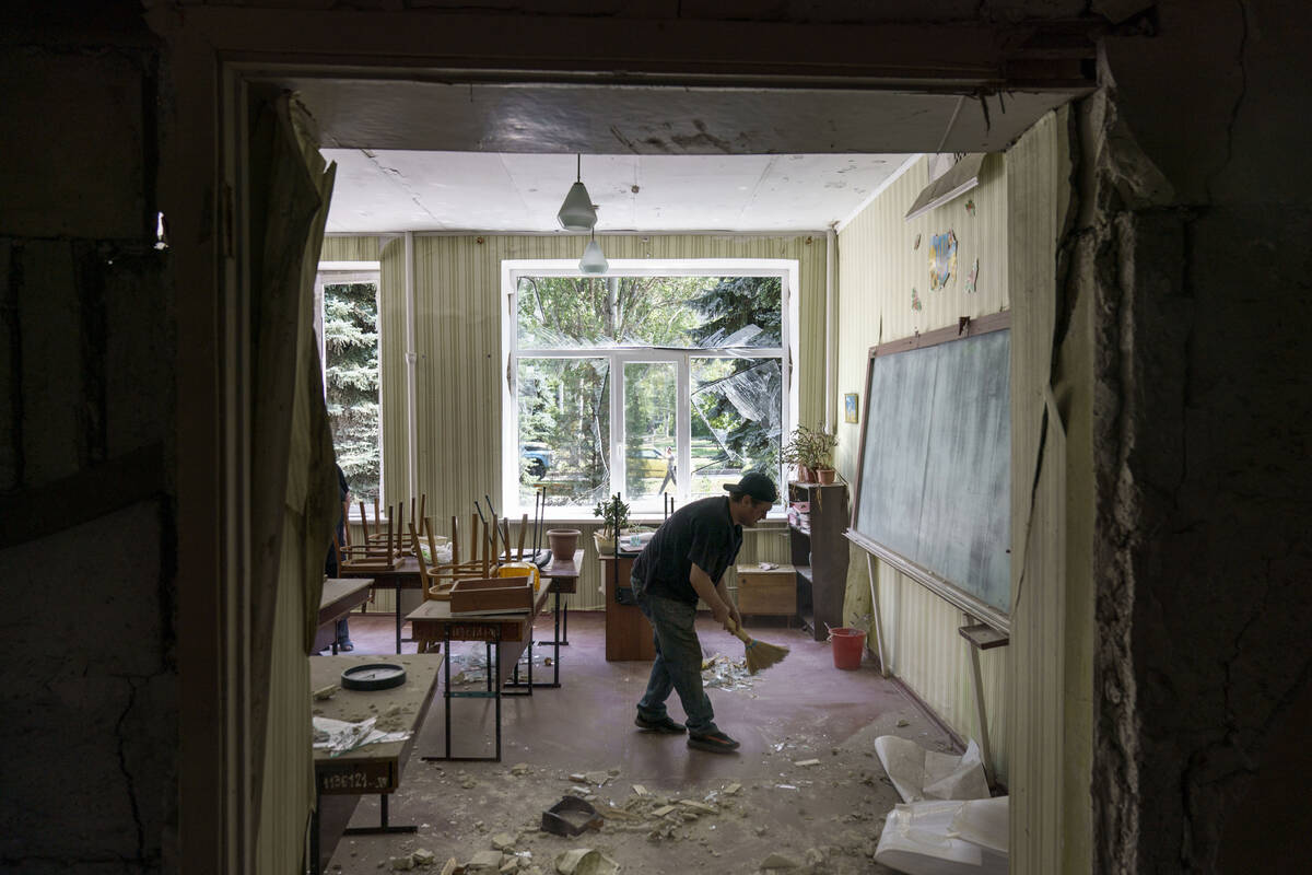 A worker cleans up after an early morning rocket attack hit the Kramatorsk College of Technolog ...