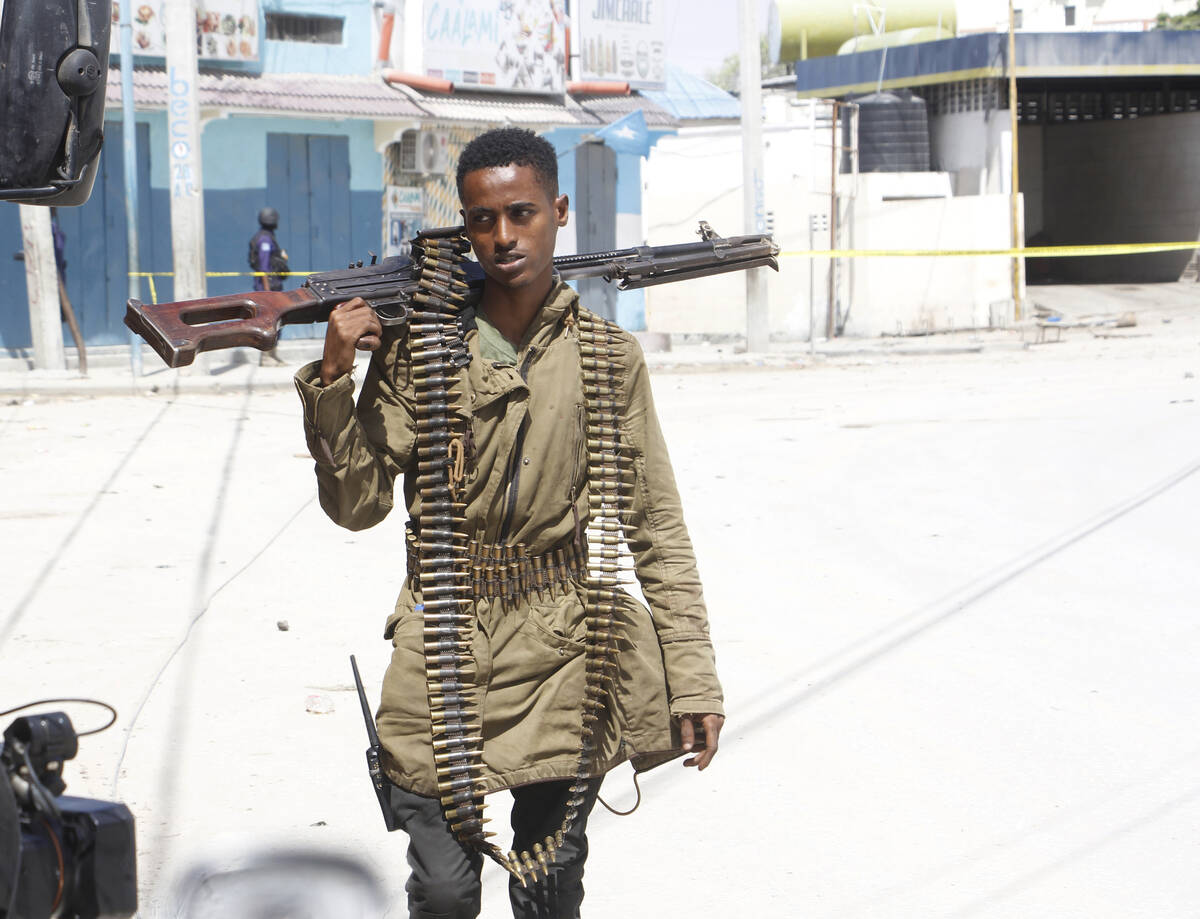 A soldier patrols outside the Hayat Hotel in Mogadishu, Somalia, Saturday, Aug. 20, 2022. At le ...