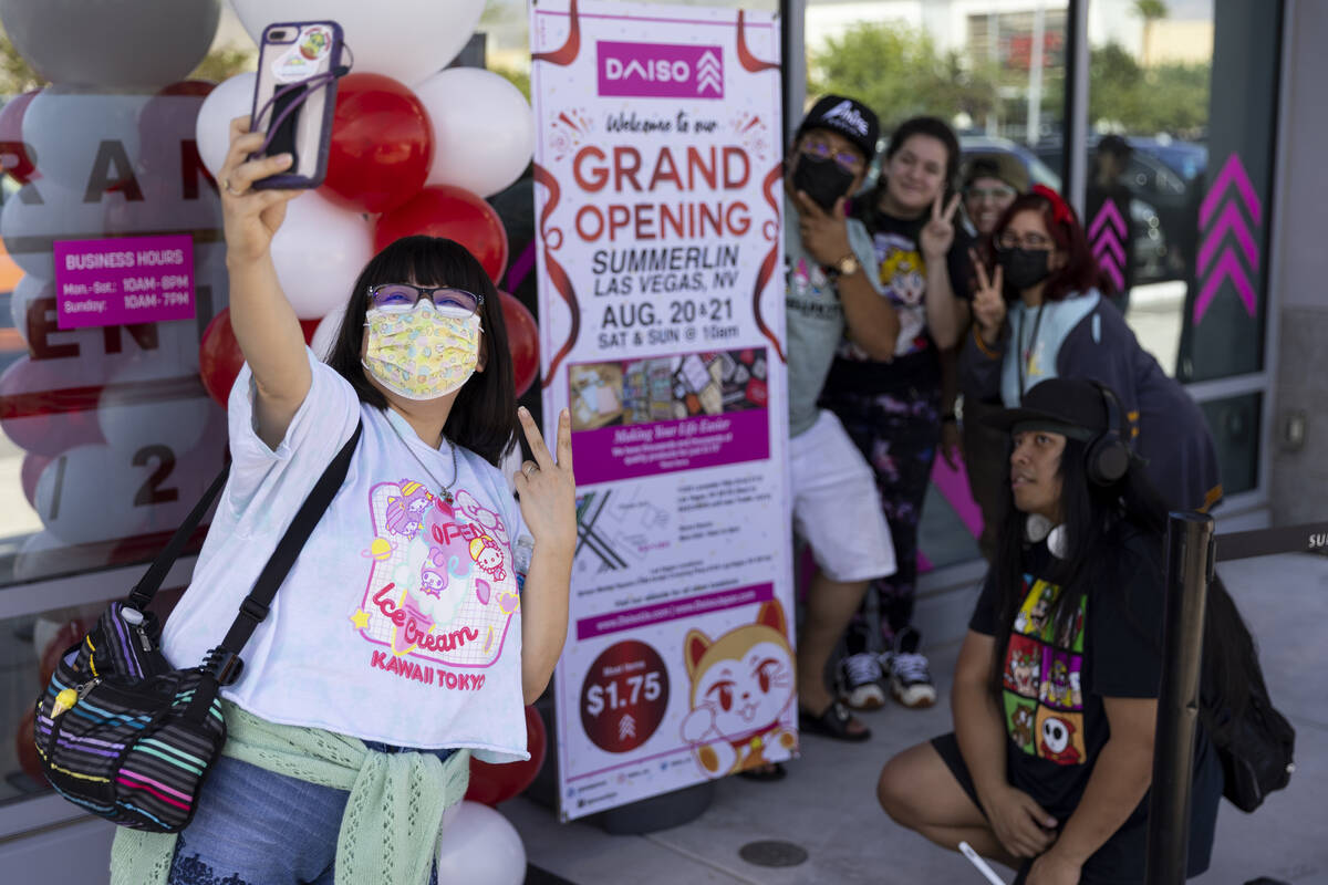 Mika Garcia of Las Vegas takes a photo with her friends outside of the newly opened Daiso store ...