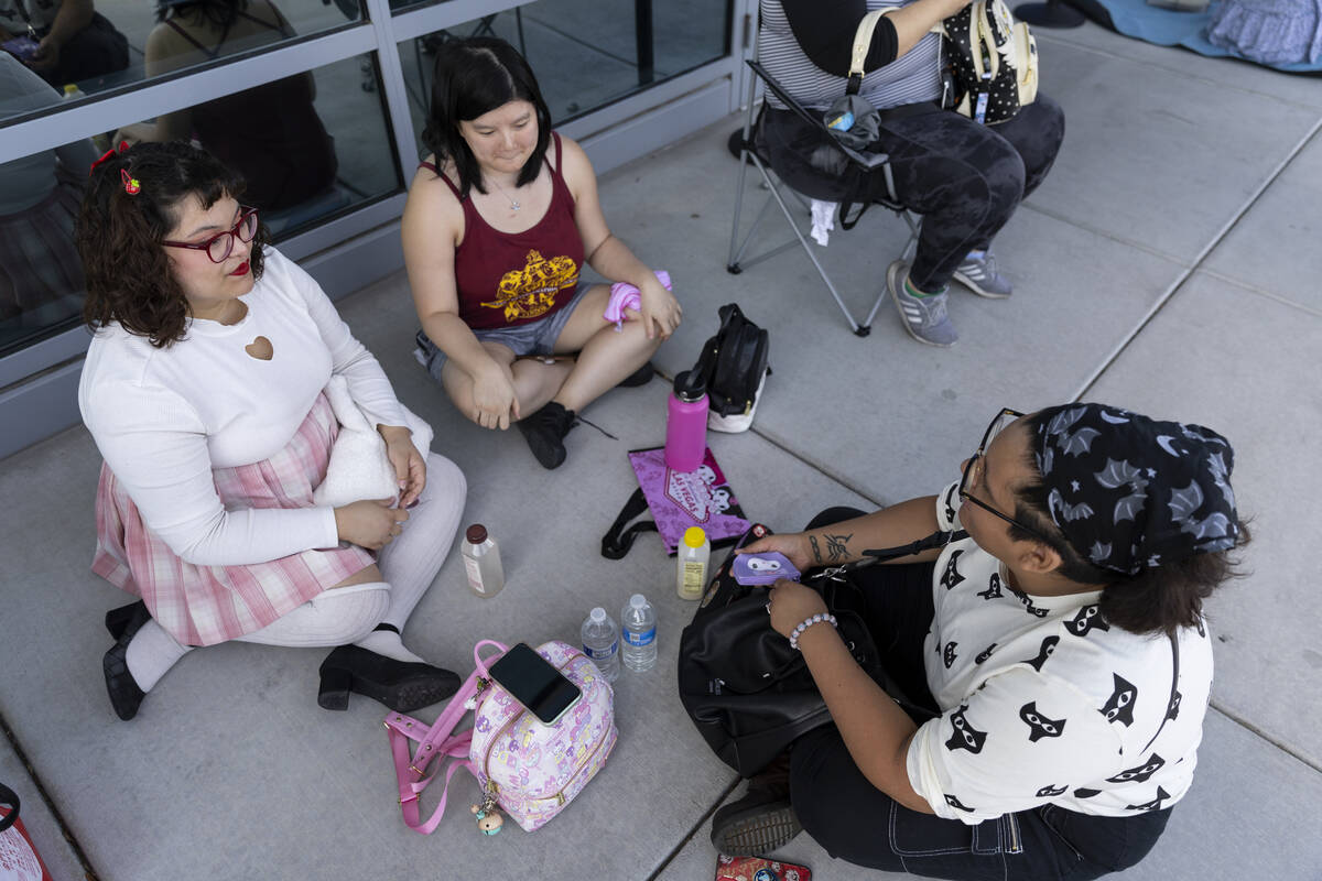 Lauren Frixione, from left, her friend Jeanie Tang, and sister Danny Frixione, wait in line dur ...