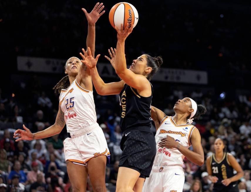 Las Vegas Aces guard Kelsey Plum (10) shoots against Phoenix Mercury guard Jennie Simms (25) an ...