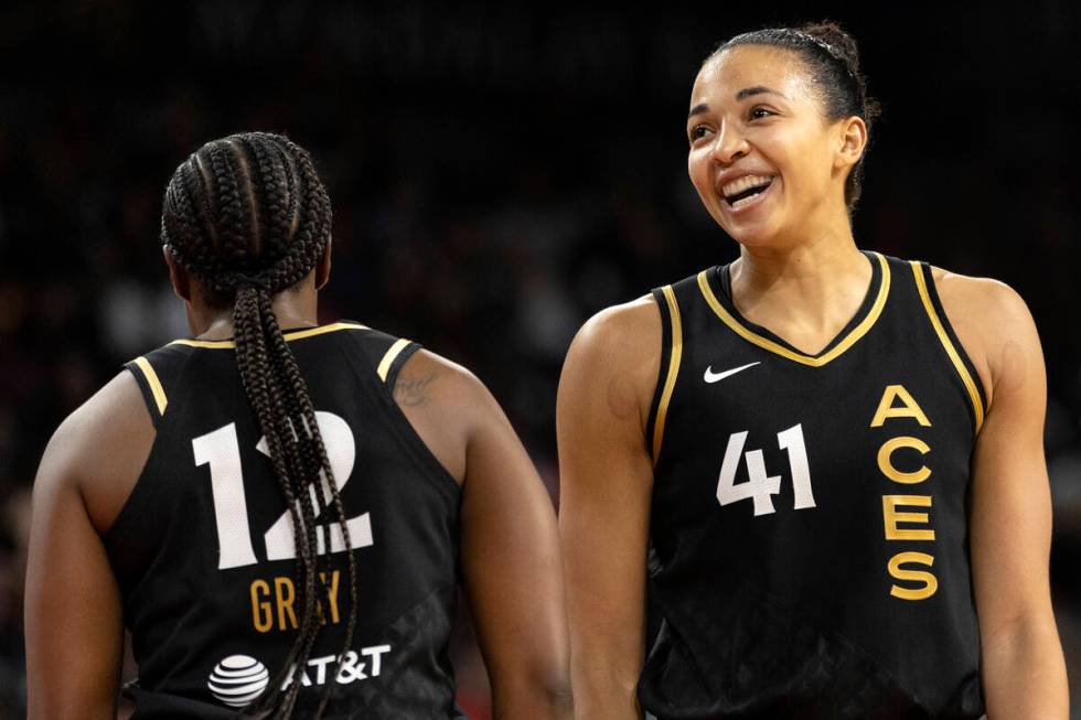 Las Vegas Aces guard Chelsea Gray (12) and center Kiah Stokes (41) celebrate after scoring duri ...