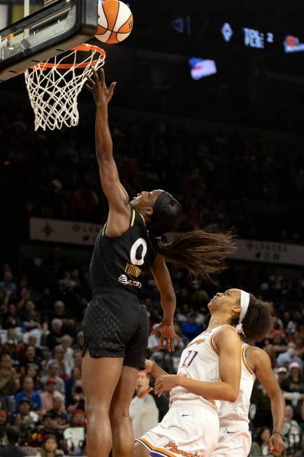 Las Vegas Aces guard Jackie Young (0) shoots against Phoenix Mercury forward Brianna Turner (21 ...