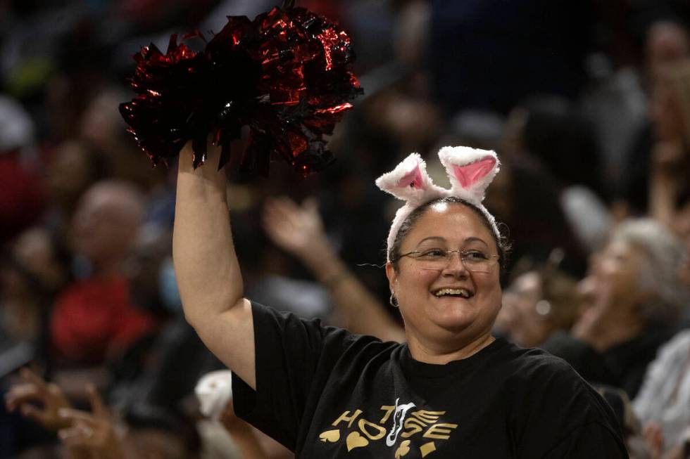 A Las Vegas Aces fan cheers from the crown during the second half of a WNBA playoff basketball ...