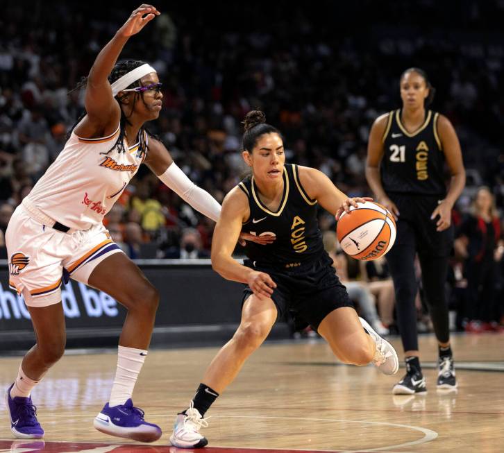 Las Vegas Aces guard Kelsey Plum (10) drives around Phoenix Mercury guard Diamond DeShields (1) ...