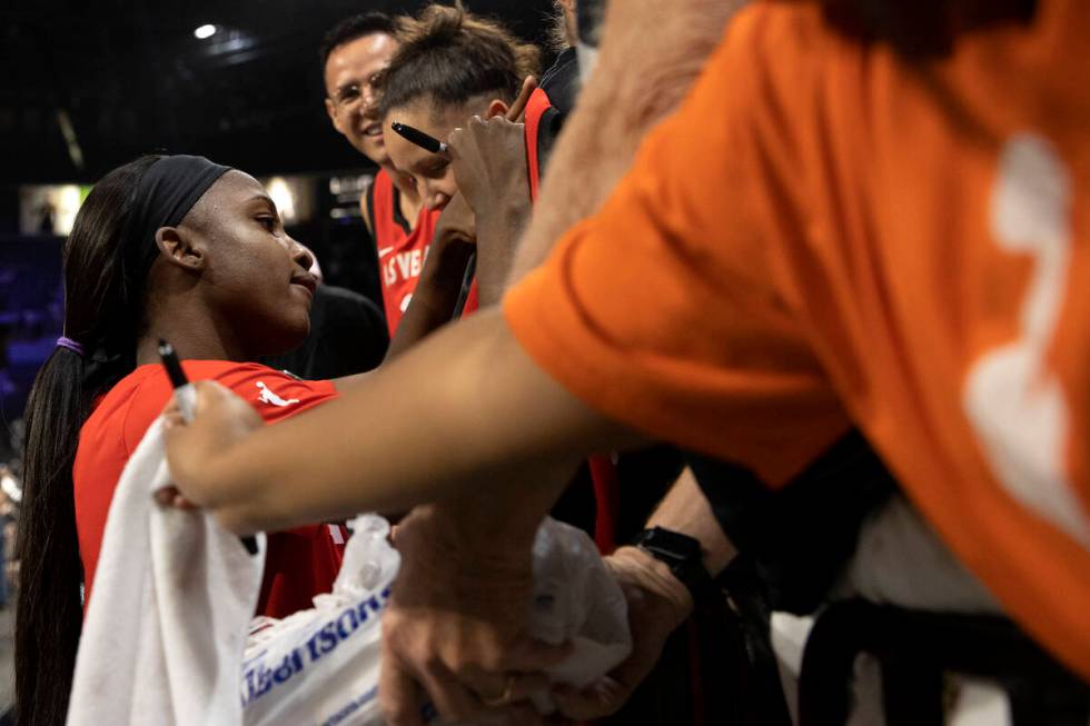Las Vegas Aces guard Jackie Young signs autographs for fans after winning a WNBA playoff basket ...