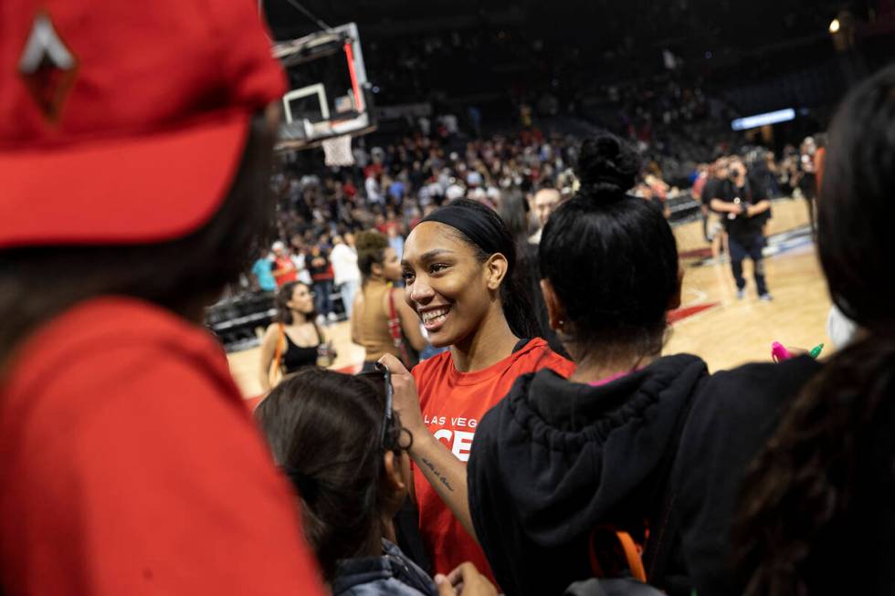 Las Vegas Aces forward A'ja Wilson, center, signs autographs for fans after winning a WNBA play ...