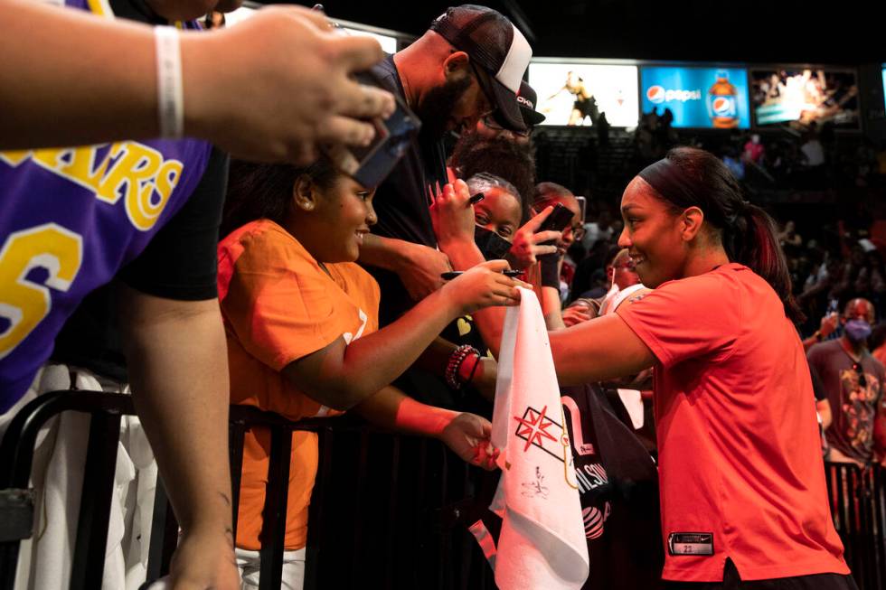 Las Vegas Aces forward A'ja Wilson, center, signs autographs for fans after winning a WNBA play ...