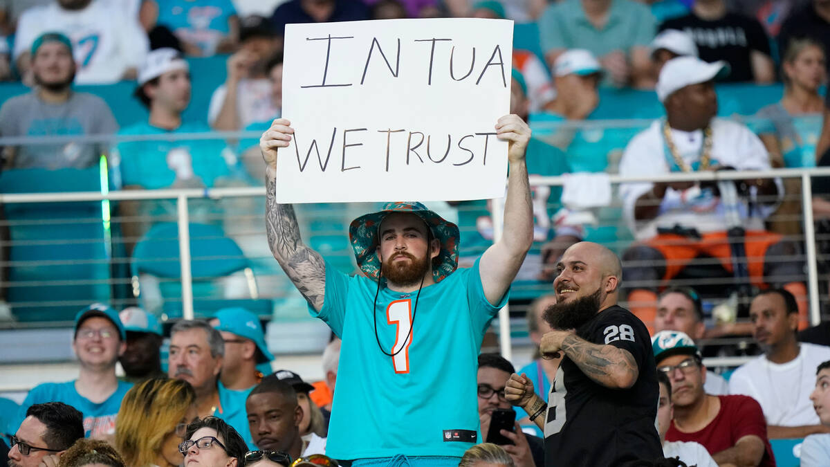 A Miami Dolphins fan raise a sign in support of quarterback Tua Tagovailoa (1) during the first ...