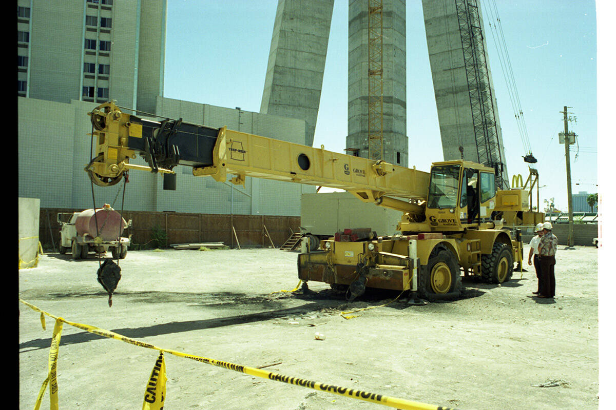 Las Vegas Fire Department inspectors examining a crane that caught fire after hitting a power l ...